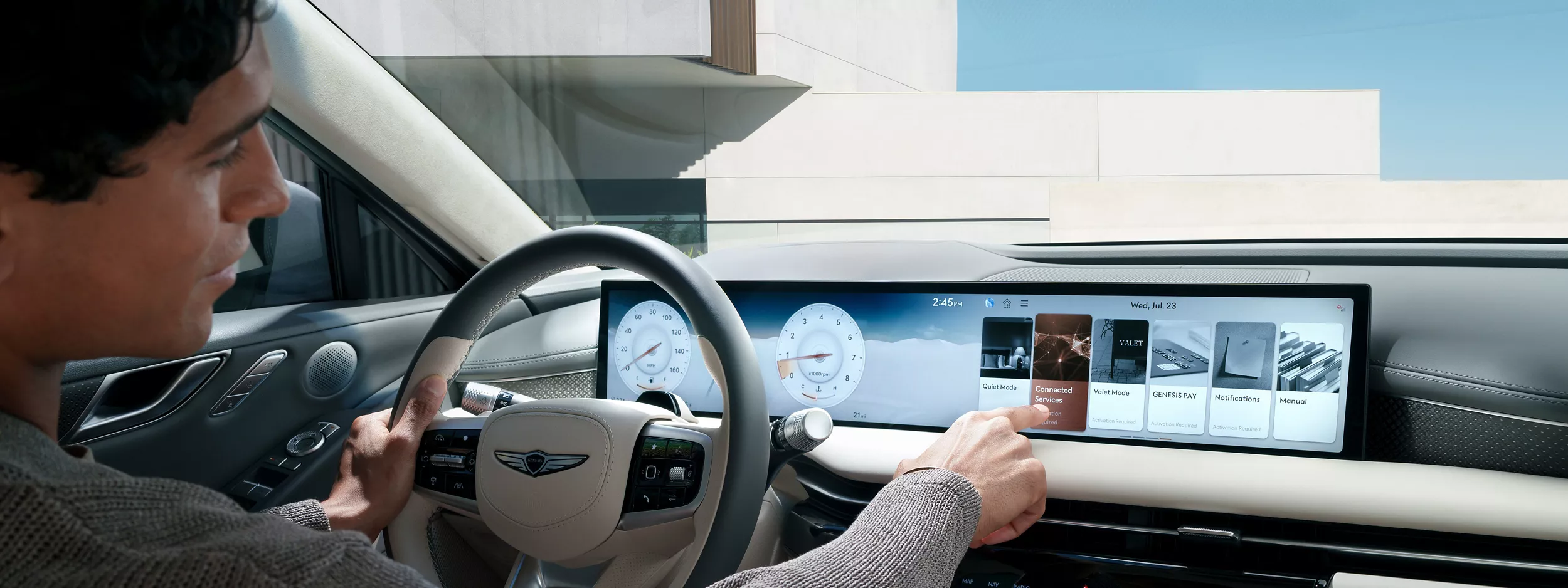 Interior over the shoulder view of driver inside Genesis G80 using 27 inch OLED display